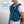 Man wearing an AlphaCool cooling vest with illuminated blue airflow graphic