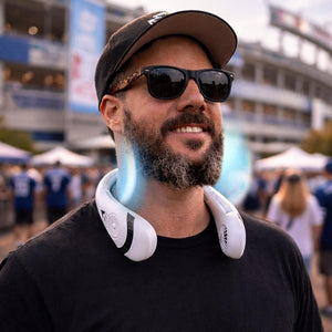 Man wearing a white portable neck fan at a stadium