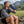 Man drinking from a blue AlphaCool water bottle outdoors