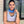 Woman wearing a blue neck gaiter and grey tank top