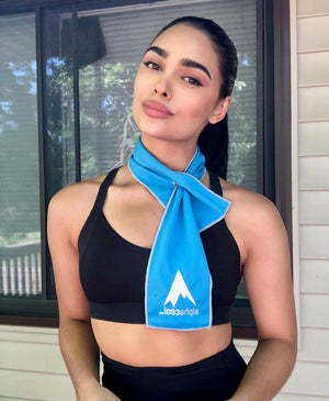 Woman wearing a blue AlphaCool cooling towel around her neck