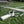 AlphaCool portable cooling device with neck strap on grass field