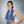 Woman wearing a blue AlphaCool cooling towel around her neck