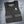 Black Alphacool cooling vest with reflective side straps on a grey background with ice cubes