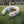 AlphaCool white portable neck fan with blue and orange cooling plates on a soccer field