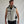 Man wearing a grey cooling vest with a built in fan on the side