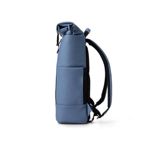 Side view of a blue roll top backpack with black straps