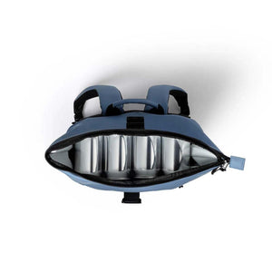 Top view of open blue cooler backpack filled with four metal beverage cans