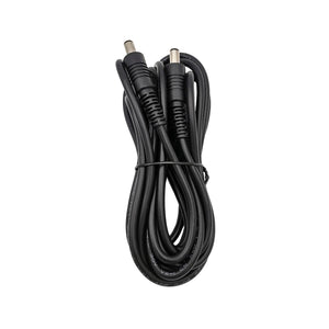 Black DC power cable with two barrel connectors coiled on white background