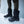 Person wearing black Baffin winter boots standing on ice