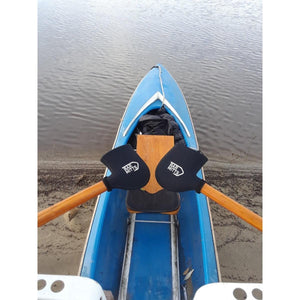 Bar Mitts handlebar covers on rowing oars inside a blue rowing shell