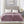 Beautyrest purple heated electric blanket on a bed with two controllers