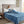 Person reading a book in bed under a blue Beautyrest electric blanket