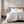 Beautyrest faux fur heated throw blanket on a bed with white bedding and wooden headboard