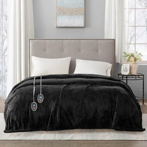 Beautyrest black heated electric blanket with dual controllers on a bed