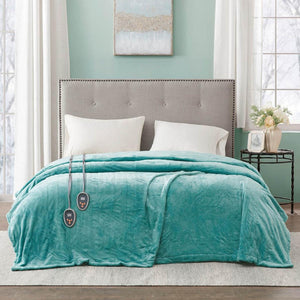 Beautyrest teal heated electric blanket with dual controllers on a bed