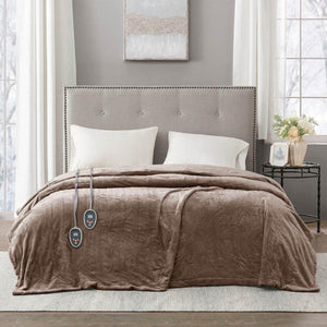 Beautyrest brown heated electric blanket with dual controllers on a bed