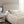 Person sleeping under a Beautyrest heated blanket on a bed with a beige upholstered headboard