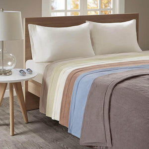 Beautyrest heated electric blanket with ribbed texture in various colors on a bed