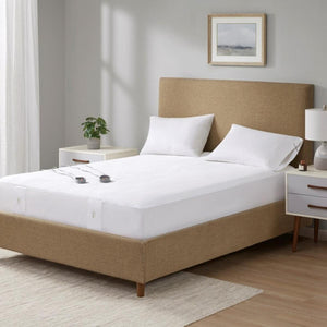 Beautyrest white heated mattress pad on a bed with two pillows