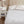 White quilted mattress protector on a bed with a bedside table