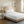 White quilted mattress protector on a bed with a beige headboard
