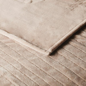 Close up of beige velvet textured bedding with stitched channel detailing