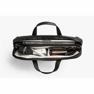 Top view of open Bellroy briefcase filled with laptop and tech accessories