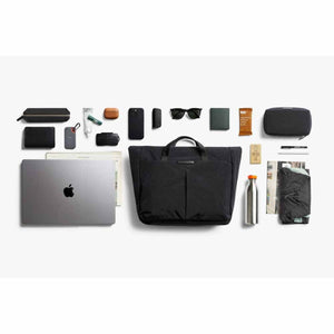 Bellroy black tote bag surrounded by organized daily carry items including a laptop and accessories