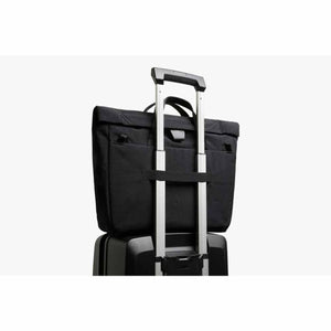 Bellroy black briefcase attached to a luggage handle