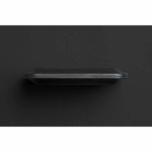 Side profile of a black Bellroy leather wallet on a dark background