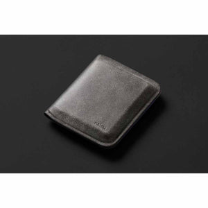 Closed Bellroy leather wallet on a dark background