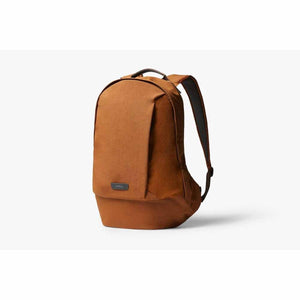 Bellroy copper colored backpack with a top handle and shoulder straps