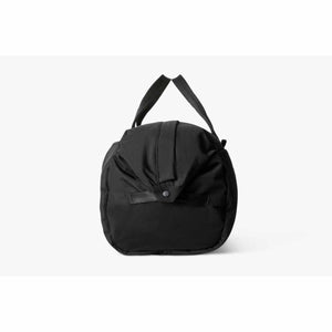Side view of a black Bellroy duffel bag