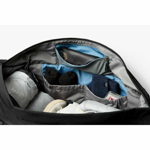 Interior view of an open Bellroy bag showing organized compartments with clothing and accessories