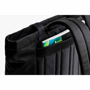 Bellroy black backpack showing a notebook tucked into the exterior pocket