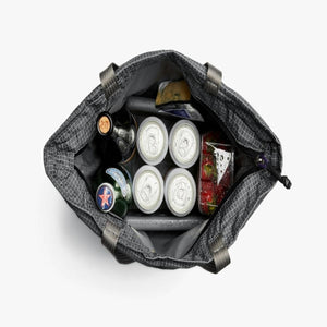 Top view of a grey grid patterned cooler bag filled with beverage cans bottles and food containers