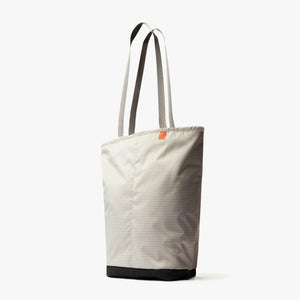 Beige tote bag with grid pattern and black base