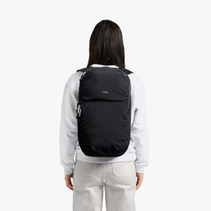 Person wearing a black Bellroy backpack viewed from behind