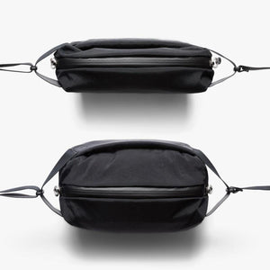 Top and side view of a black Bellroy sling bag with a zippered closure
