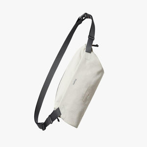 Bellroy cream colored sling bag with adjustable black strap