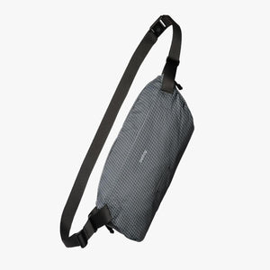 Bellroy grey grid pattern sling bag with black adjustable strap