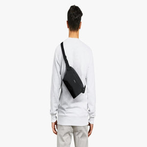 Person wearing a black Bellroy sling bag across their back
