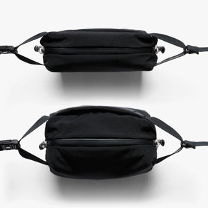 Top and bottom views of a black Bellroy sling bag with zipper closure