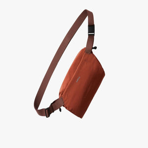 Bellroy rust colored sling bag with adjustable strap
