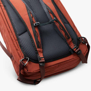 Back panel and shoulder straps of a terracotta Bellroy backpack featuring black mesh padding
