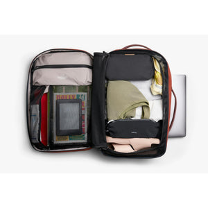 Open Bellroy travel backpack packed with clothing and accessories