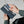 Hands removing a card from a Bellroy leather wallet