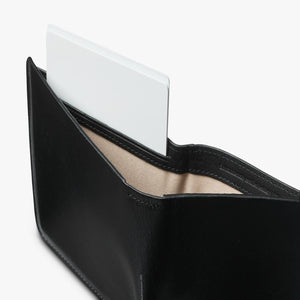 Bellroy black leather wallet with a white card inserted in the slot