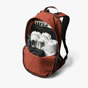 Open Bellroy backpack packed with shoes and clothing